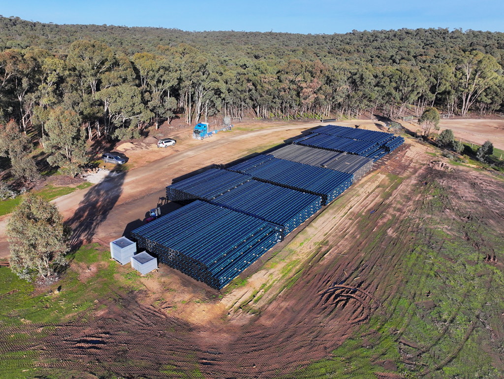 Aerial view of a many lengths of HDPE pipe stacked on site