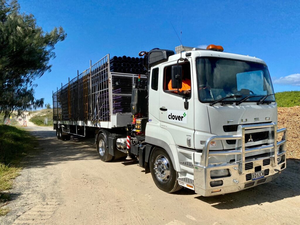 Clover branded truck carry polyethylene pipe