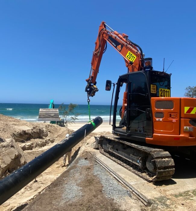 excavator digging a trench for pipe