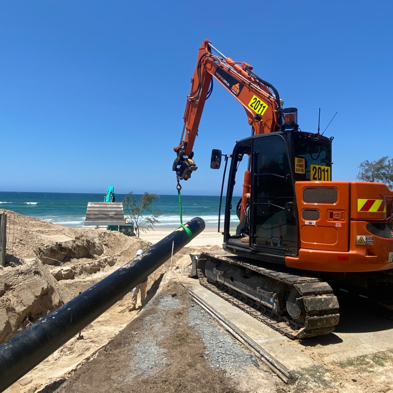 excavator digging a trench for pipe