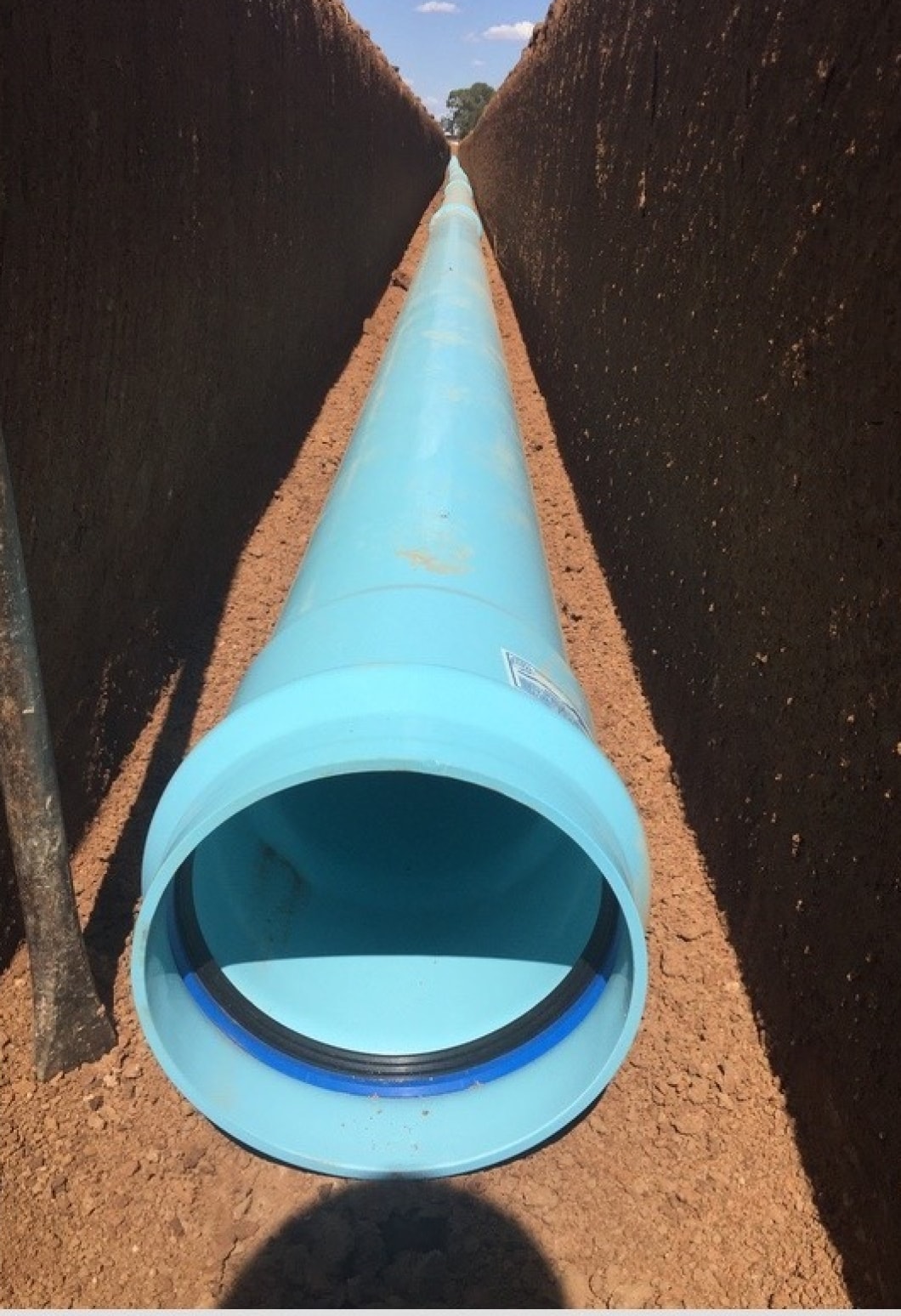 PVC-O pipe in a trench, from perspective of bottom of trench